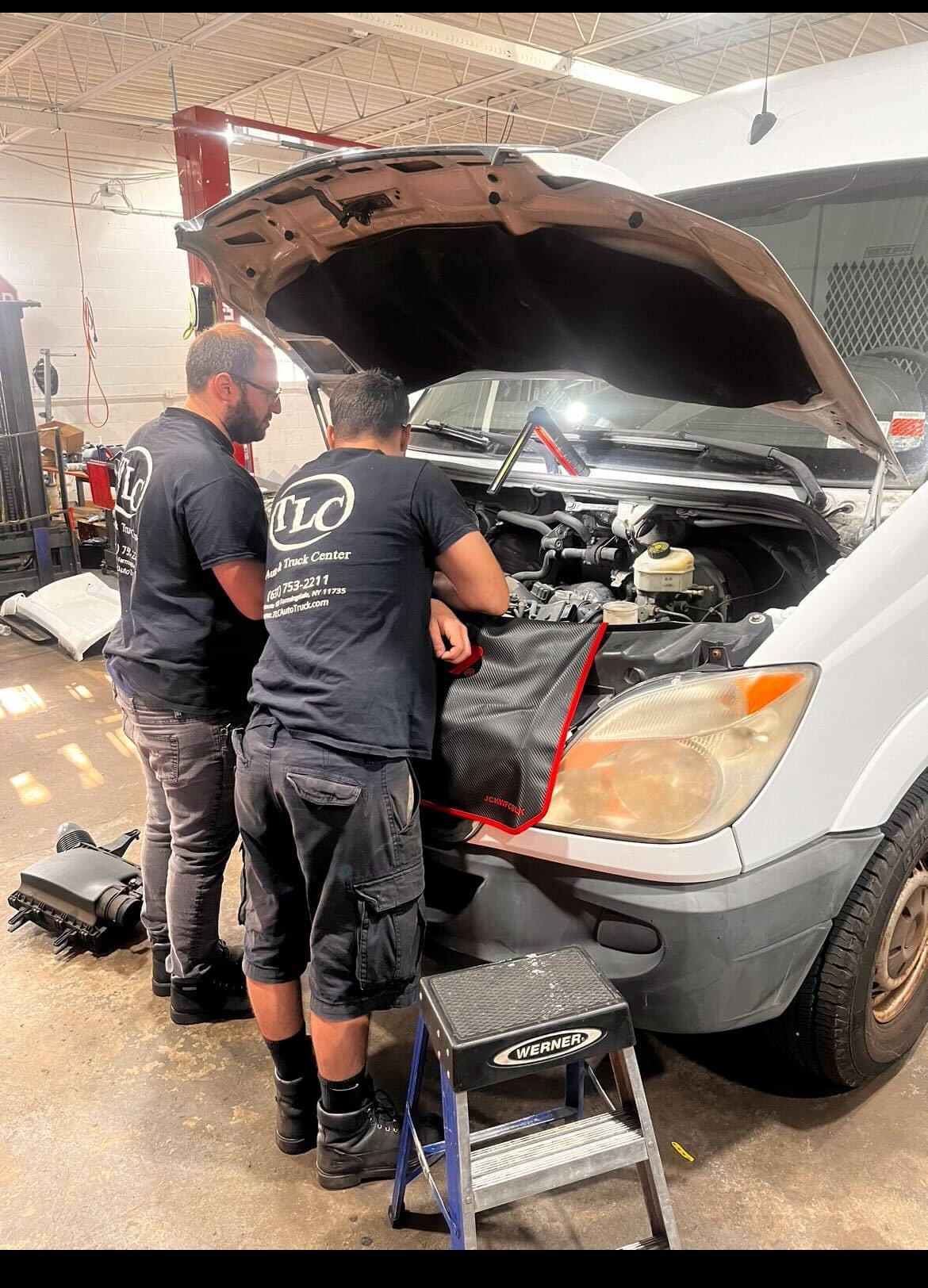 TLC workers in front of van