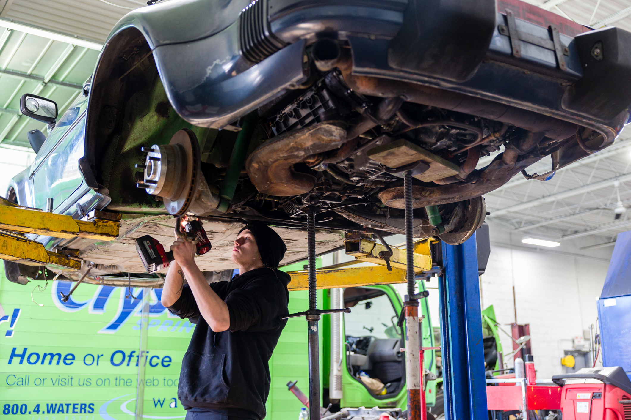 tlc auto truck mechanic under car lift